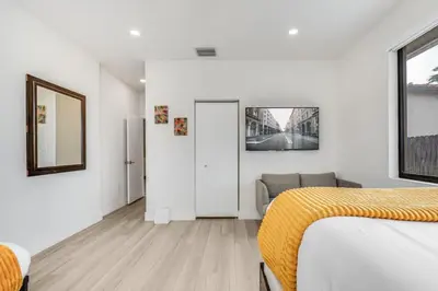 a bedroom with a bed and a couch in it at Fox Sonata Downtown Pool House home in Fort Lauderdale