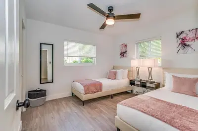a bedroom with two beds and a ceiling fan at Friendly Fox Luxury Pool & Spa - Near DT & Beach home in Fort Lauderdale