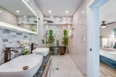 a white bathroom with a tub and a sink at Friendly Fox Luxury Pool & Spa - Near DT & Beach home in Fort Lauderdale