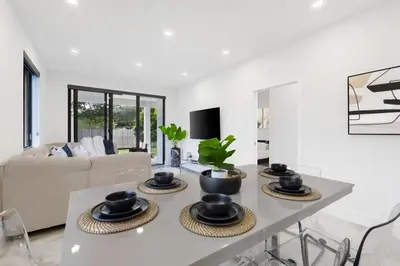 a white living room with a table with bowls on it at Golden Fox Downtown Pool House home in Fort Lauderdale