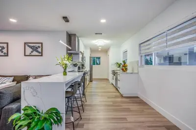 a kitchen and living room with a couch and a table at Fox Private Resort- Near Downtown & Beach home in Fort Lauderdale
