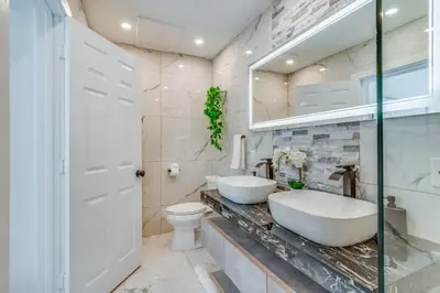 a bathroom with two sinks and a toilet at Fox Private Resort- Near Downtown & Beach home in Fort Lauderdale