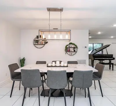 a dining room with a table and chairs and a piano at Fox Private Resort- Near Downtown & Beach home in Fort Lauderdale
