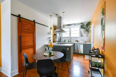 a kitchen and dining room with a table and chairs at Designer 2br, king-size bed, 5mins to the beach J1 in Hollywood