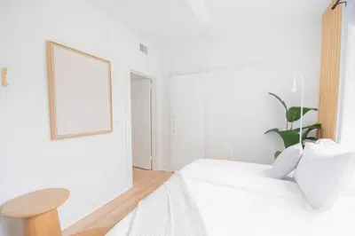 a white room with a white bed and a table at Stylish 2br apt, 5 mins to the BEACH J2 in Hollywood