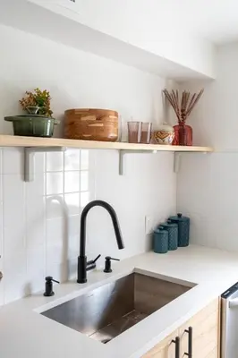 a kitchen counter with a sink and shelves at Designer Gem Condo - 5 Mins to Sand, Playground, Tennis, Free Parking in Hollywood
