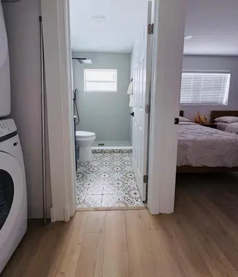 a bathroom with a bed and a toilet in a room at Modern Hollywood Beach Retreat 2BDx2BTH - Games, WiFi, AC in Hollywood