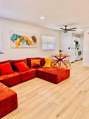 a living room with a red couch and a table at Modern Hollywood Beach Retreat 2BDx2BTH - Games, WiFi, AC in Hollywood