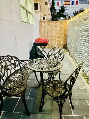 a table and two chairs sitting on a patio at Modern Hollywood Beach Retreat 2BDx2BTH - Games, WiFi, AC in Hollywood