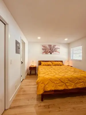 a bedroom with a bed with a yellow bedspread at Modern Hollywood Beach Retreat 2BDx2BTH - Games, WiFi, AC in Hollywood