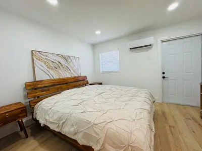 a bedroom with a bed and a white wall at Modern Hollywood Beach Retreat 2BDx2BTH - Games, WiFi, AC in Hollywood