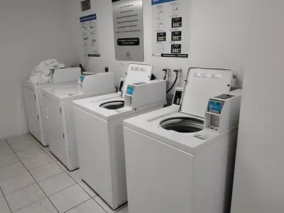 a row of washers and dryers in a room at Ocean reserve 2 bedroom plus den in Sunny Isles Beach