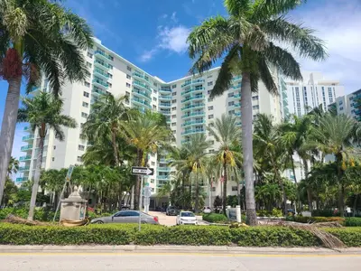a large building with palm trees in front of it at Lovely condo on the Beach - Tides Hollywood 14th Floor in Hollywood