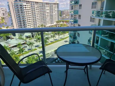 a table and chairs on a balcony with a view of a city at Lovely condo on the Beach - Tides Hollywood 14th Floor in Hollywood