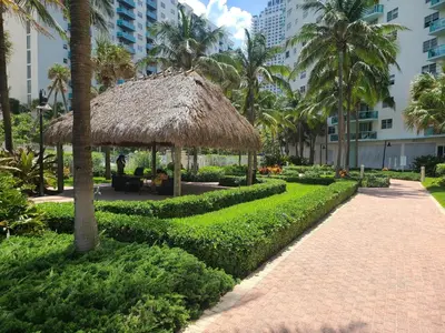 a pavilion with a straw roof in a park at Lovely condo on the Beach - Tides Hollywood 14th Floor in Hollywood