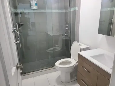 a bathroom with a shower and a toilet and a sink at Lovely condo on the Beach - Tides Hollywood 14th Floor in Hollywood