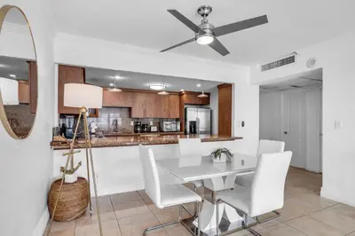 a kitchen and dining room with a white table and chairs at Resort at Sunny Isles Beach with Ocean view in Sunny Isles Beach