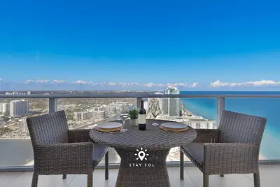 a table and chairs with a view of the ocean at Stunning 1BR Apt With Ocean View Balcony in Hollywood
