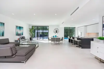 a living room with a couch and a table at Luxe Pool House in North Miami Perfect for Groups in North Miami Beach