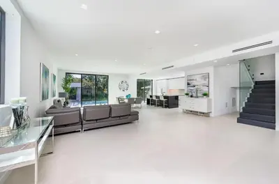 a living room with a couch and a table at Luxe Pool House in North Miami Perfect for Groups in North Miami Beach