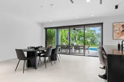 a dining room with a black table and chairs at Absolut Luxe 5 Bed Villa with Pool- Great for Group in North Miami Beach