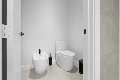 a bathroom with a toilet and a sink at Absolut Luxe 5 Bed Villa with Pool- Great for Group in North Miami Beach