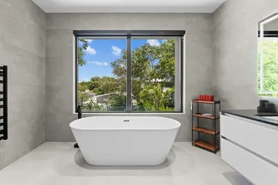 a white bathroom with a large window and a tub at Absolut Luxe 5 Bed Villa with Pool- Great for Group in North Miami Beach