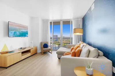 a living room with a couch and a table at Stylish 1BR High Rise Retreat w Ocean View in Hallandale Beach