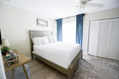 a bedroom with a bed and a ceiling fan at The Hamptons Hideaway in Hollywood