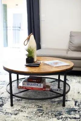 a coffee table with a book and a plant on it at The Hamptons Hideaway in Hollywood