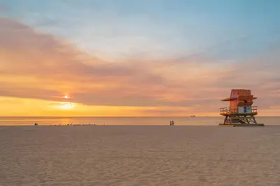 a lifeguard tower on a beach at sunset at Maison Felix in Miami Beach