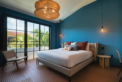 a bedroom with a large bed and a large window at Maison Felix in Miami Beach