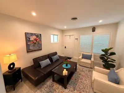 a living room with a couch and a table at The Pines Hideaway-Your Home Away from Home in Fort Lauderdale