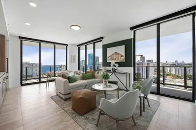 a living room with a couch and chairs and windows at Ocean Dreams Chic 2BR Getaway Minutes from Miami's Top Attractions in Miami Beach