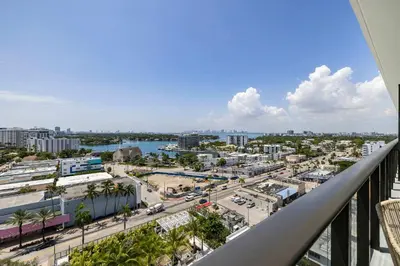 a view of a city from a balcony at Miami Beach Retreat Cozy 1BR Steps from the Shore in Miami Beach