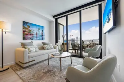 a living room with a couch and a table at Miami Beach Retreat Cozy 1BR Steps from the Shore in Miami Beach