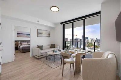 a living room with a table and chairs and a couch at Chic Miami Retreat Stylish 2BR Gem for 5 in Miami Beach