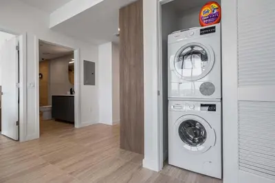 a laundry room with a washer and dryer in a house at Chic Miami Retreat Stylish 2BR Gem for 5 in Miami Beach