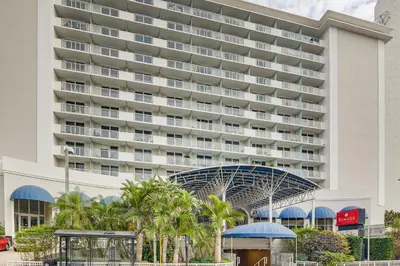 a hotel in front of a large building at Oceanfront Resort Condo with Gym and Waterfront Pool! in Sunny Isles Beach
