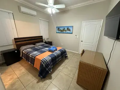a bedroom with a bed and a ceiling fan at The Garden House in Miami Lakes in Miami Lakes