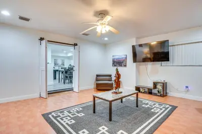 a living room with a ceiling fan and a table at Game Day Made Easy Home 3 Mi to Hard Rock Stadium in Miami Gardens