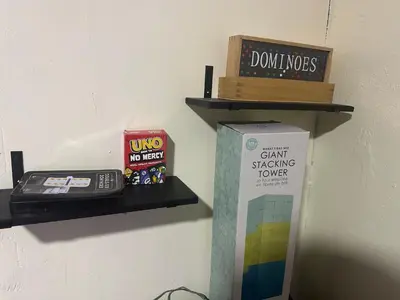 a wall shelf with a phone and a book at Miramar near Hard Rock stadium in Miramar