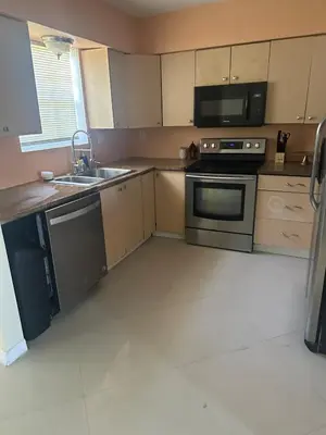 a kitchen with a sink and a stove top oven at Miramar near Hard Rock stadium in Miramar
