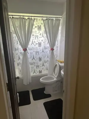 a bathroom with a toilet and a shower curtain at Miramar near Hard Rock stadium in Miramar