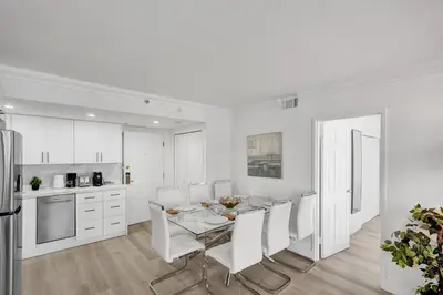 a kitchen and dining room with a table and chairs at Gorgeous Ocean View 3BD Condo in Beachfront Resort 907 in Miami Beach