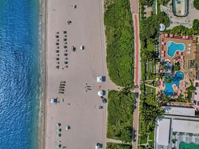 an overhead view of a beach next to the water at Gorgeous Ocean View 3BD Condo in Beachfront Resort 907 in Miami Beach