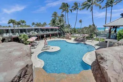 a swimming pool at a resort with palm trees at Luxury Oceanfront Condo 2BR 2.5BA with 700Sqft Terrace Sauna Resort Amenities and Pools 1501 in Miami Beach