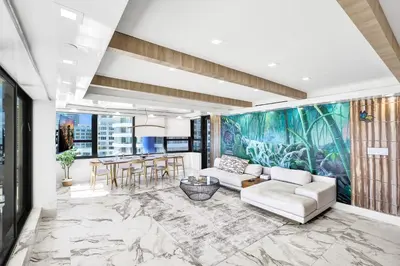 a living room with a large painting on the wall at Luxury Oceanfront Condo 2BR 2.5BA with 700Sqft Terrace Sauna Resort Amenities and Pools 1501 in Miami Beach