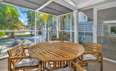 a porch with a wooden table and two chairs at Casa Verde - Wilton Manors - Pool in Fort Lauderdale