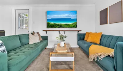 a living room with two green couches and a table at Casa Verde - Wilton Manors - Pool in Fort Lauderdale